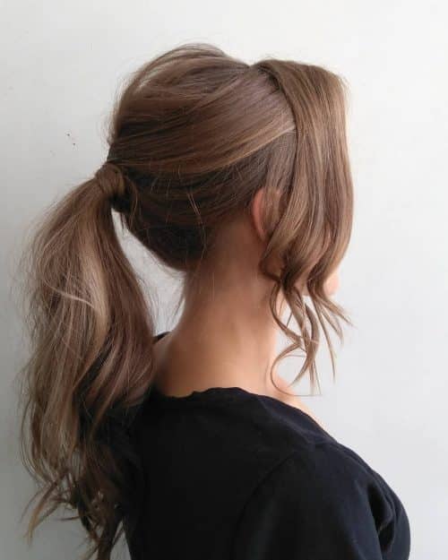 A ponytail alongside bangs is a hairstyle where the pilus is pulled dorsum from the human face upward fifteen Cutest Examples of a Ponytail alongside Bangs