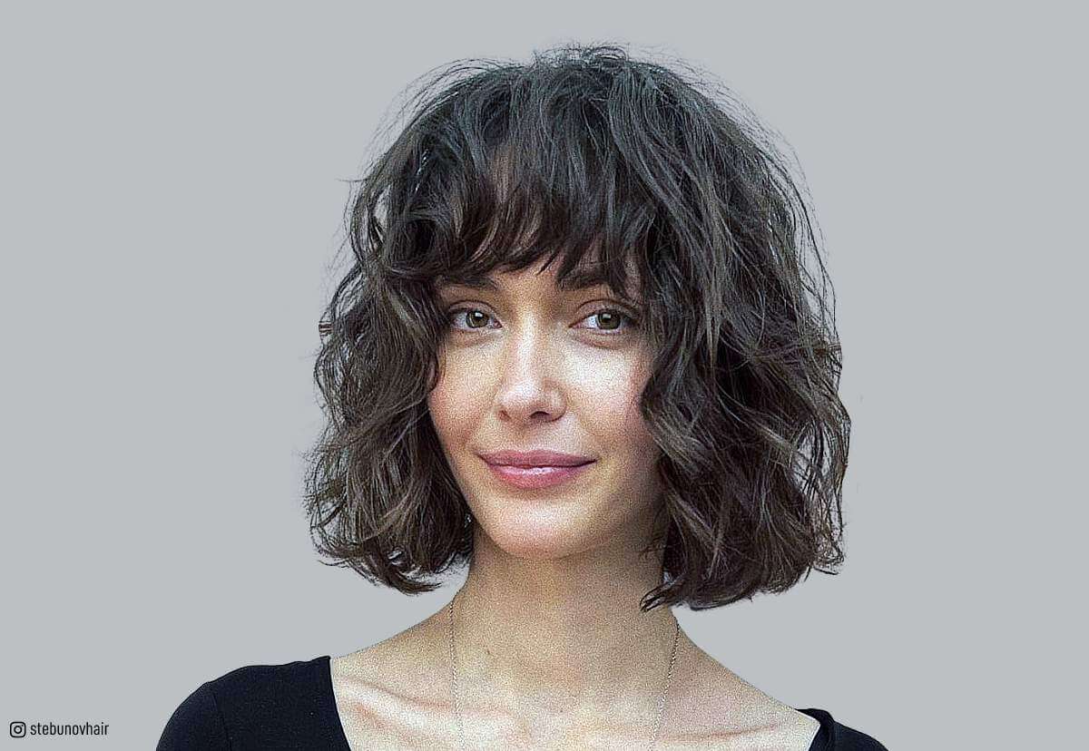 Image of Curly blunt bangs with a pixie cut